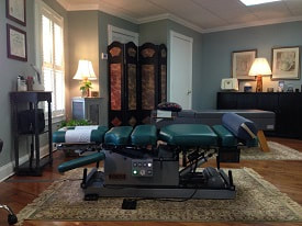 Picture of beautiful office showing the Cox Flexion / Distraction table and Activator Chiropractic instrument.
